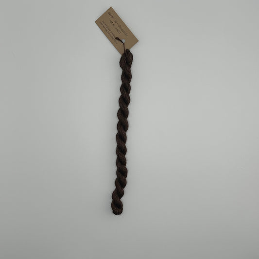 30 yard skein of silk & Ivory in the color 16 Chocolate with brown tag laying flat on white background