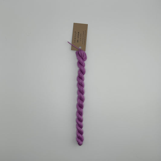 30 yard skein of silk & Ivory in the color 193 Crocus with brown tag laying flat on white background