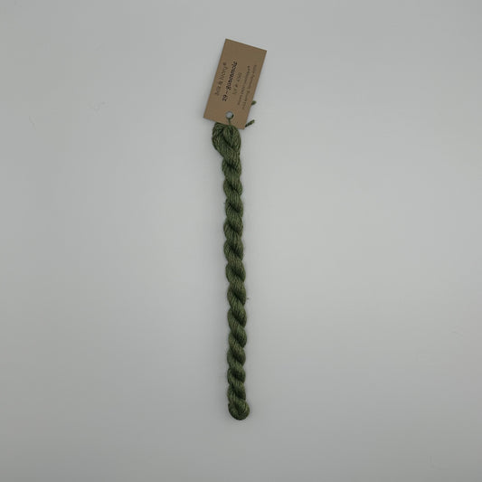 30 yard skein of silk & Ivory in the color 29 Guacamole with brown tag laying flat on white background