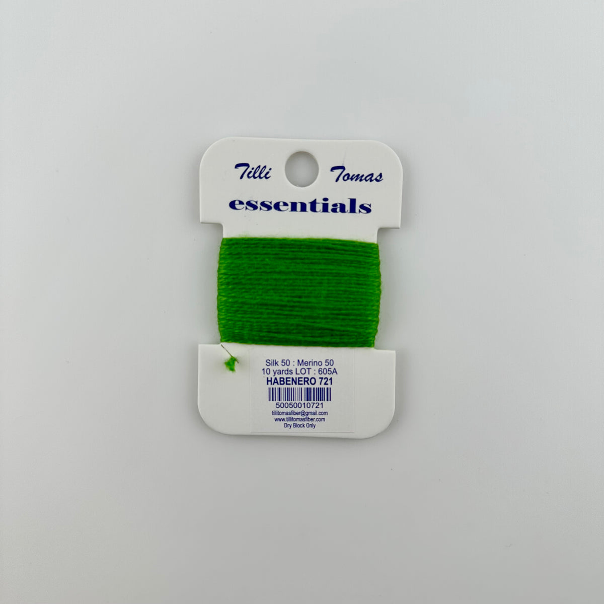 Tilli Tomas Essentials needlepoint thread, in a green habenero 721.  50% silk, 50% merino wool, 10 yards wound on a white cardboard card.