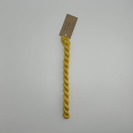 30 yard skein of silk & Ivory in the color 241 Maize with brown tag laying flat on white background