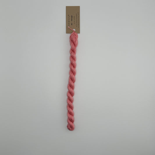 30 yard skein of silk & Ivory in the color 96 Mango with brown tag laying flat on white background