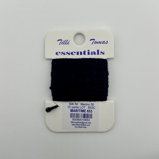 Tilli Tomas Essentials needlepoint thread, in dark navy blue maritime 653.  50% silk, 50% merino wool, 10 yards wound on a white cardboard card.