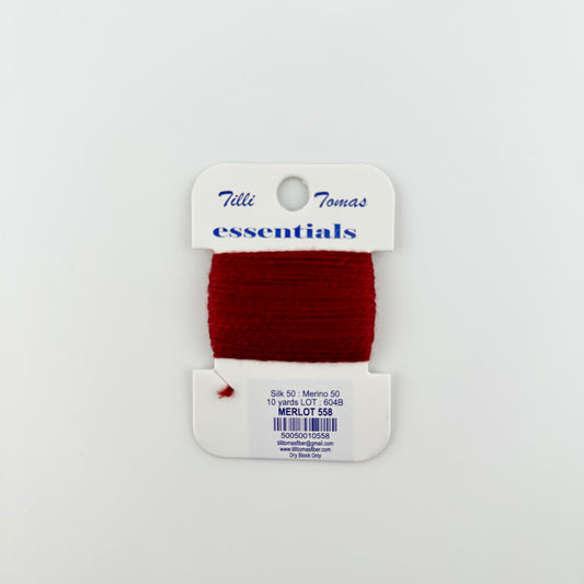 Tilli Tomas Essentials needlepoint thread, in red merlot 558.  50% silk, 50% merino wool, 10 yards wound on a white cardboard card.