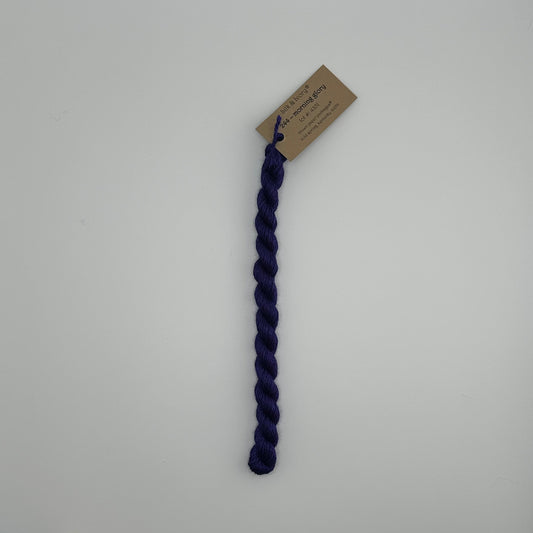 30 yard skein of silk & Ivory in the color 244 Morning Glory with brown tag laying flat on white background