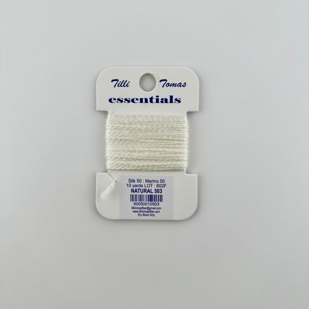 Tilli Tomas Essentials needlepoint thread, in white natural 503.  50% silk, 50% merino wool, 10 yards wound on a white cardboard card.
