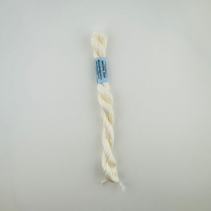 30 yard skein of essentials needlepoint thread in Natural S503, with blue label lying flat on white background