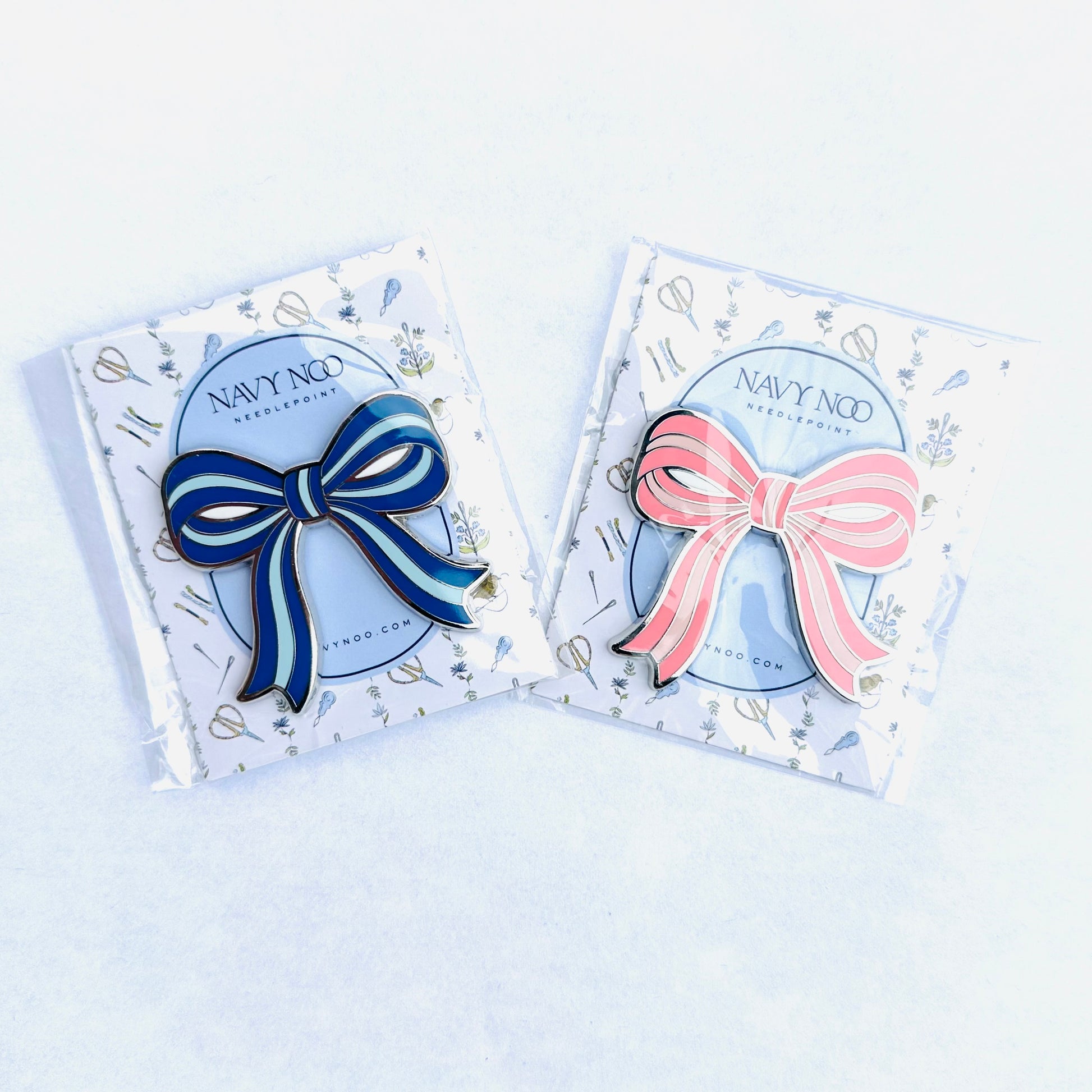 two magnetic needle minder. one pink and one blue by Navy Noo, displayed on its branded white backing card inside a clear plastic sleeve, set against a clean white background.