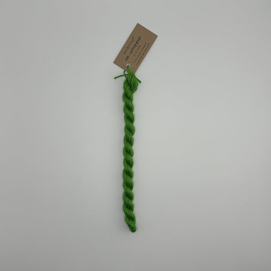 30 yard skein of silk & Ivory in the color 229 Putting Green with brown tag laying flat on white background