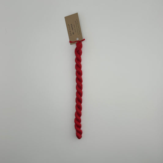 30 yard skein of silk & Ivory in the color 93 Red Hot with brown tag laying flat on white background