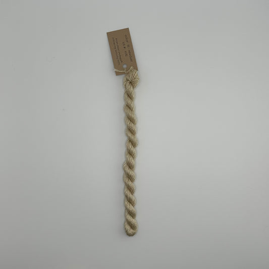 30 yard skein of silk & Ivory in the color 81 Sawdust with brown tag laying flat on white background