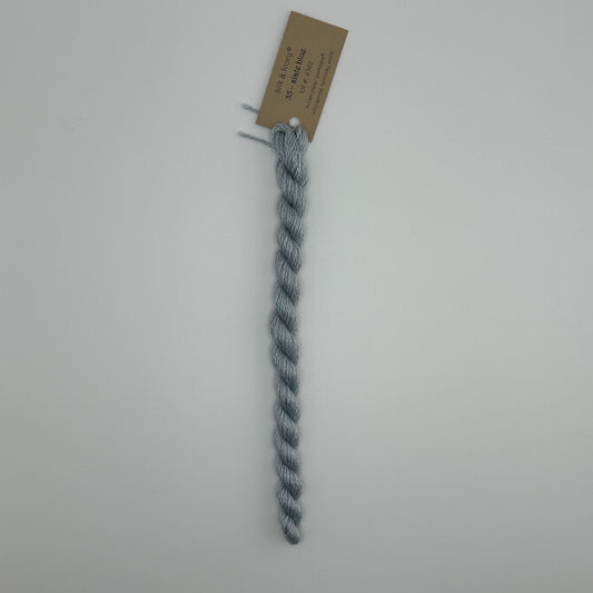 30 yard skein of silk & Ivory in the color 35 Slate Blue with brown tag laying flat on white background