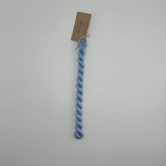 30 yard skein of silk & Ivory in the color 32 True Blue with brown tag laying flat on white background